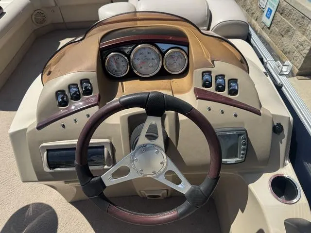 Slide: The Image of 2010 Bennington 2250RCW Pontoon dashboard with steering wheel and gauges. - 27