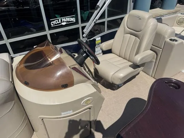 Slide: The Image of 2010 Bennington 2250RCW Pontoon boat interior with captain's chair and steering console. - 28
