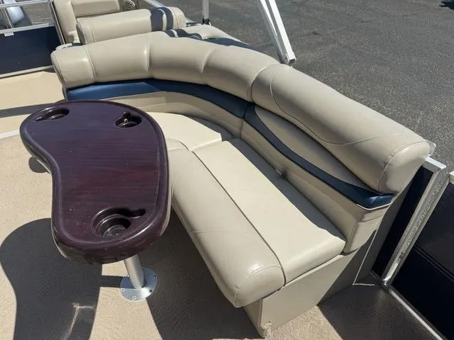 Slide: The Image of 2010 Bennington 2250RCW Pontoon with beige seating and wooden table. - 29