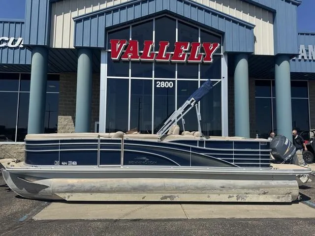 Slide: The Image of 2010 Bennington 2250RCW Pontoon boat displayed outside Vallely dealership. - 3