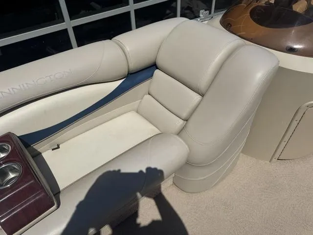 Slide: The Image of 2010 Bennington 2250RCW Pontoon boat interior with beige seating and cup holders. - 30