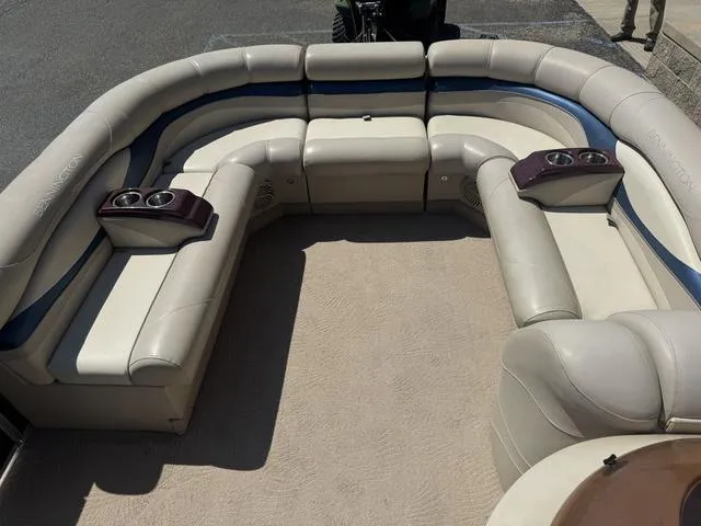 Slide: The Image of 2010 Bennington 2250RCW Pontoon interior with beige seating and cup holders. - 36