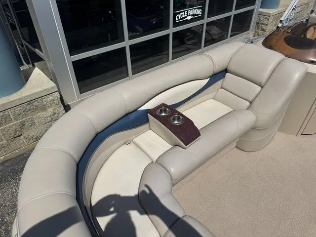 Slide: The Image of 2010 Bennington 2250RCW Pontoon boat seating with cup holders, beige upholstery. - 37