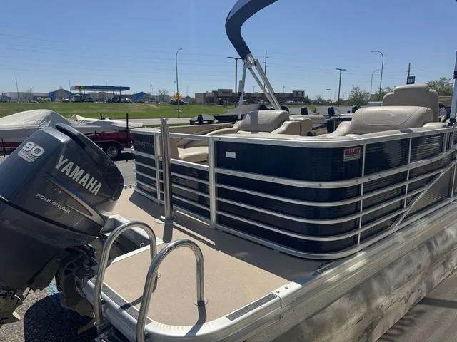 Slide: The Image of 2010 Bennington 2250RCW Pontoon with Yamaha motor, parked outdoors on a sunny day. - 9