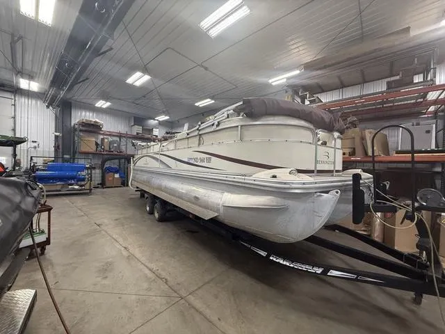 Slide: The Image of 2005 Bennington 2575RLX Pontoon boat stored indoors on a trailer. - 1