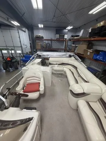 Slide: The Image of 2005 Bennington 2575RLX Pontoon boat with spacious seating in a well-lit garage. - 11