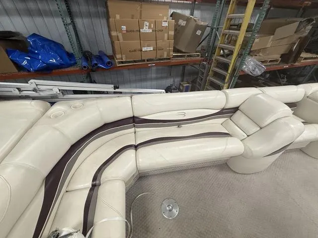 Slide: The Image of 2005 Bennington 2575RLX Pontoon boat interior with beige seating in a storage area. - 6