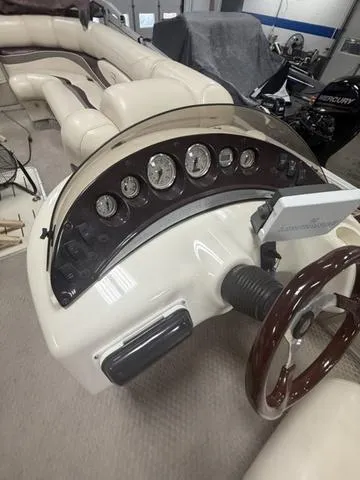Slide: The Image of 2005 Bennington 2575RLX Pontoon boat dashboard with gauges and steering wheel. - 9