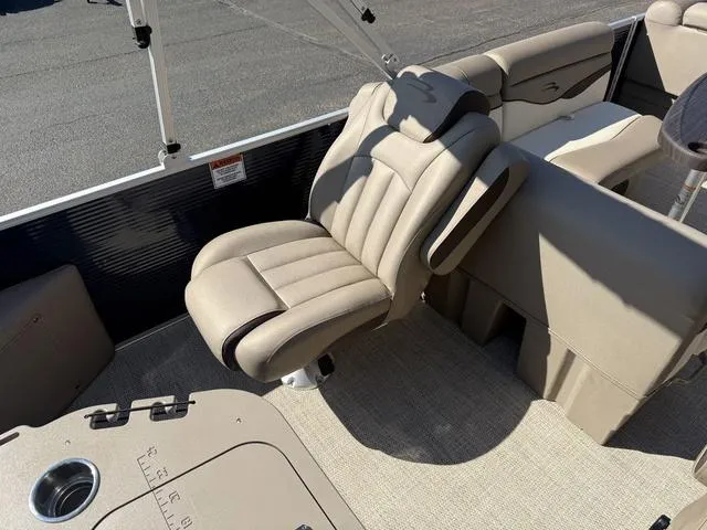 Slide: The Image of 2019 Bennington 21 SSX boat interior with beige seating and carpeted flooring. - 11