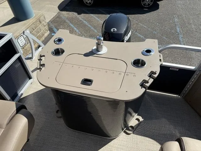 Slide: The Image of 2019 Bennington 21 SSX boat with Evinrude motor, featuring a beige control panel. - 13