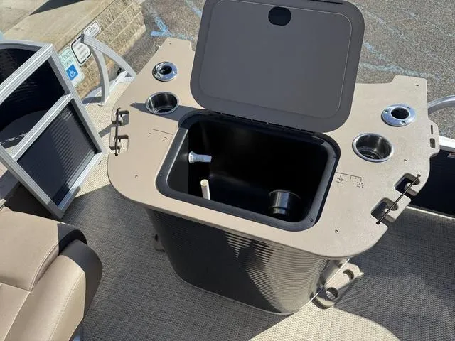 Slide: The Image of 2019 Bennington 21 SSX boat with open storage compartment and cup holders. - 14