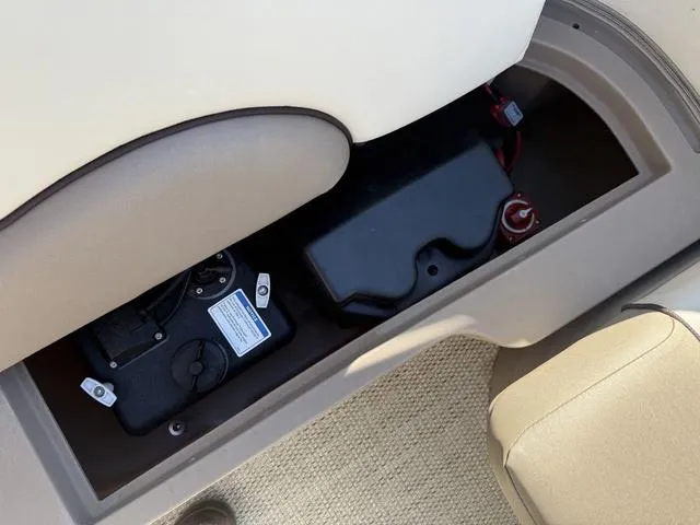 Slide: The Image of 2019 Bennington 21 SSX boat storage compartment with battery and wiring. - 18