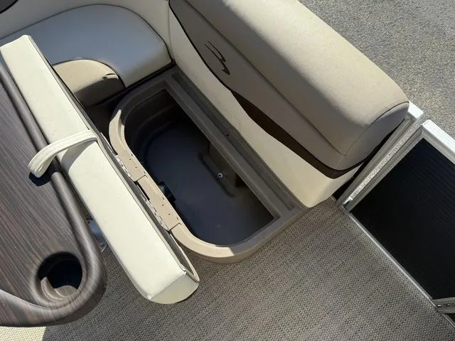 Slide: The Image of 2019 Bennington 21 SSX boat interior with open storage compartment and seating. - 19
