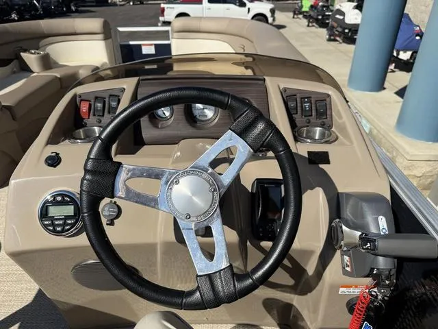 Slide: The Image of 2019 Bennington 21 SSX boat dashboard with steering wheel and control panel. - 21