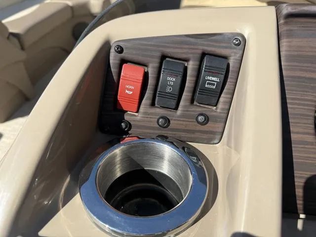 Slide: The Image of Control panel of 2019 Bennington 21 SSX boat with switches and cup holder. - 25