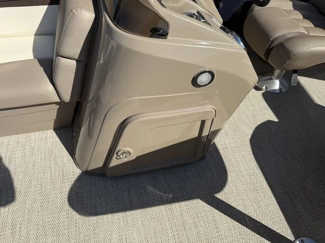 Slide: The Image of 2019 Bennington 21 SSX boat interior with beige seating and console. - 27