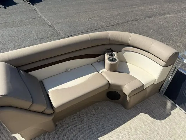 Slide: The Image of 2019 Bennington 21 SSX boat interior with beige seating and cup holders. - 29