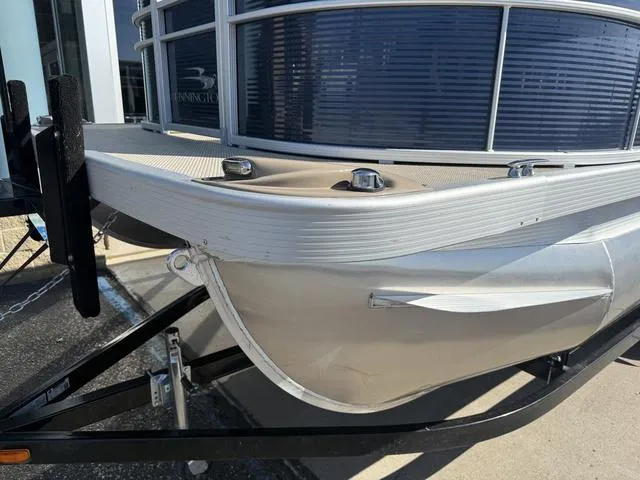 Slide: The Image of 2019 Bennington 21 SSX pontoon boat on trailer, close-up of bow and railing. - 3