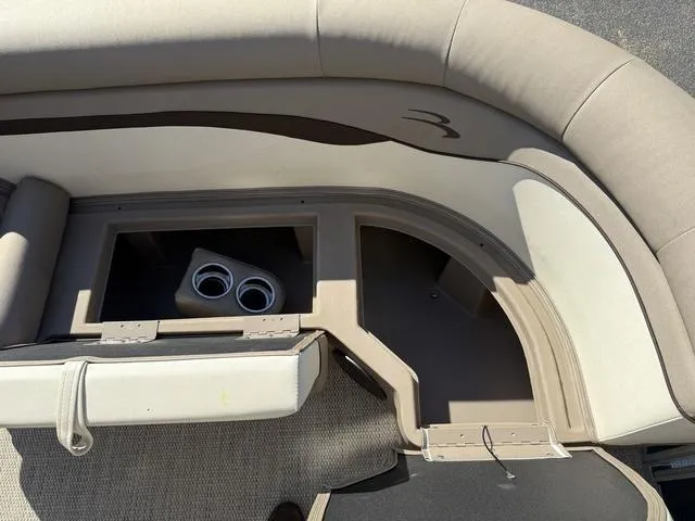 Slide: The Image of Interior seating of a 2019 Bennington 21 SSX boat with storage and cup holders. - 31