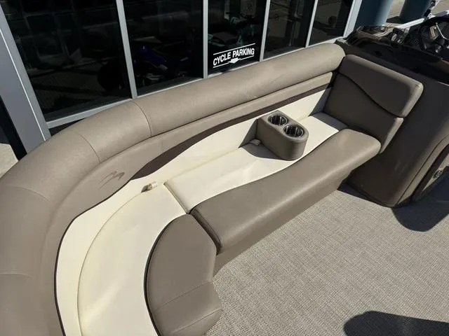 Slide: The Image of 2019 Bennington 21 SSX boat interior with beige seating and cup holders. - 33