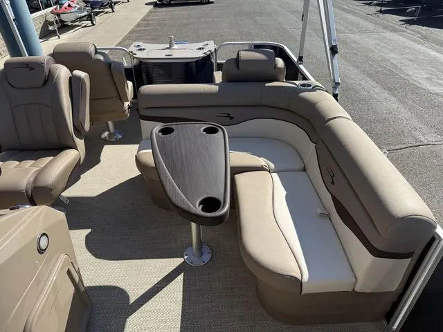 Slide: The Image of 2019 Bennington 21 SSX pontoon boat interior with beige seating and a central table. - 37