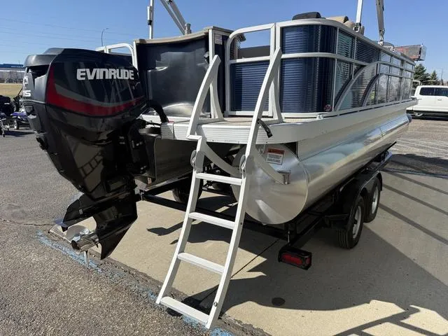 Slide: The Image of 2019 Bennington 21 SSX pontoon boat with Evinrude motor and ladder, parked on trailer. - 9