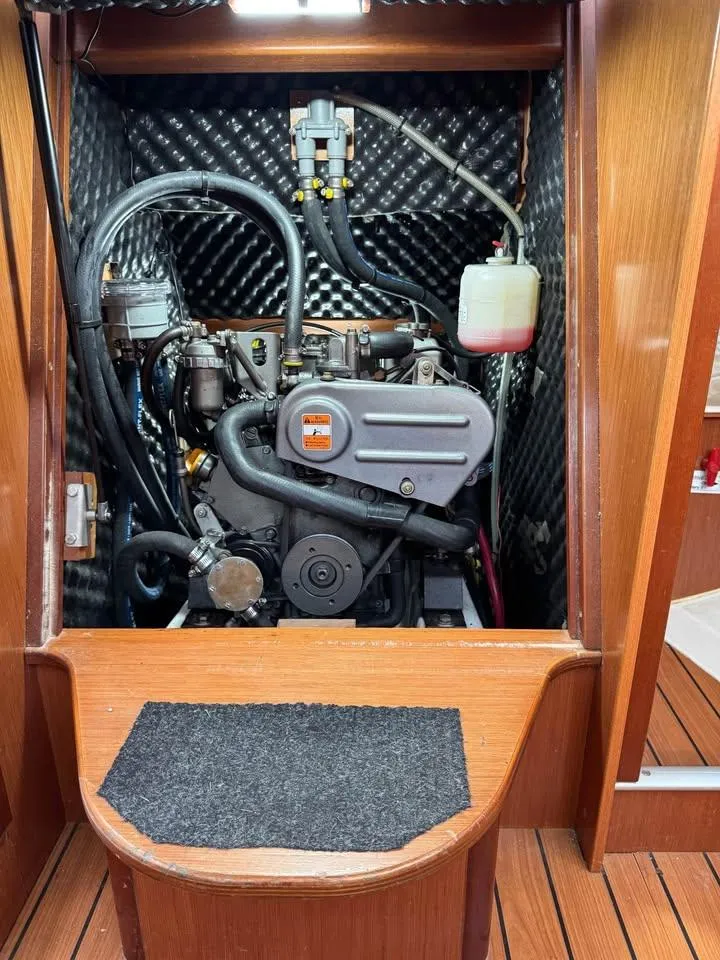Slide: The Image of Engine compartment of a 2008 Beneteau 343 sailboat, showcasing the engine and surrounding components. - 14