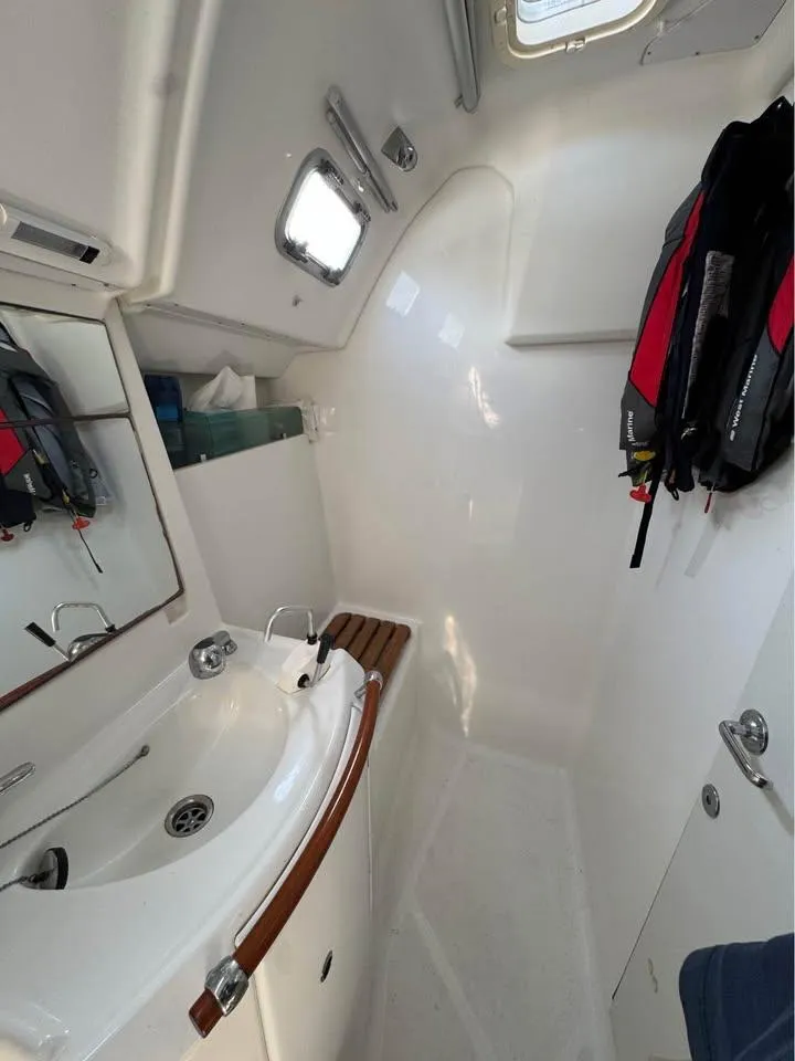 Slide: The Image of Beneteau 343 (2008) yacht bathroom with sink, mirror, and life jackets. - 16