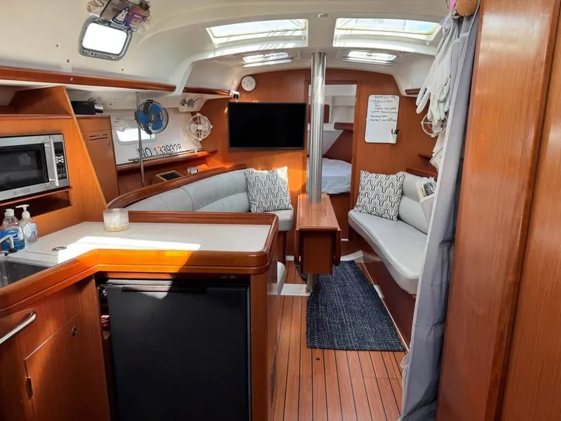 Slide: The Image of Interior of a 2008 Beneteau 343 sailboat with modern amenities and cozy seating. - 6