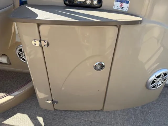 Slide: The Image of 2016 Regency 254 DL3 boat interior with beige cabinet and speaker. - 10