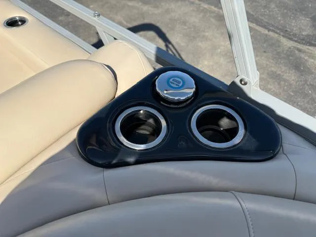 Slide: The Image of Cup holders on a 2016 Regency 254 DL3 boat with beige seating. - 13