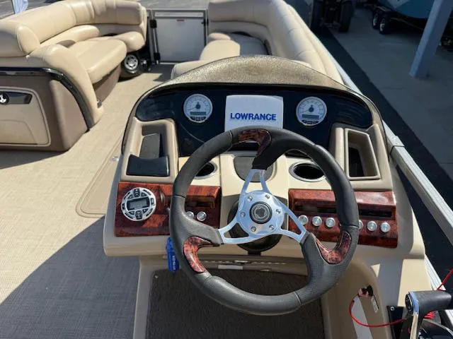 Slide: The Image of 2016 Regency 254 DL3 boat interior with steering wheel and dashboard controls. - 15