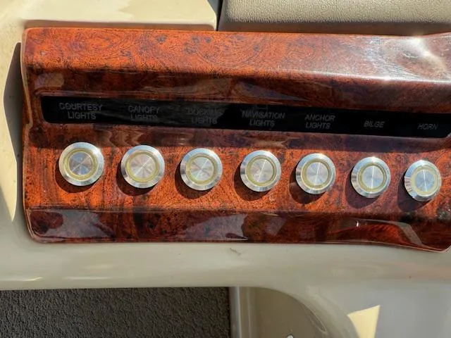 Slide: The Image of Control panel of a 2016 Regency 254 DL3 boat with labeled switches for various functions. - 20