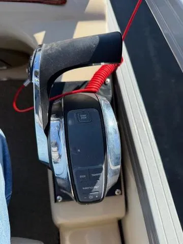 Slide: The Image of Throttle control of a 2016 Regency 254 DL3 boat with a red safety lanyard. - 21