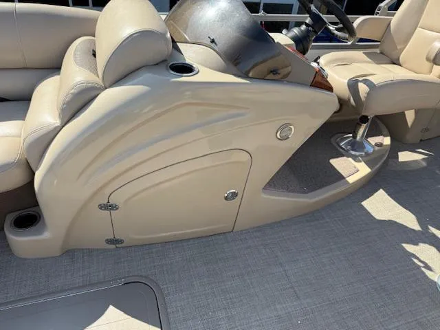 Slide: The Image of 2016 Regency 254 DL3 boat interior with beige seating and steering console. - 22