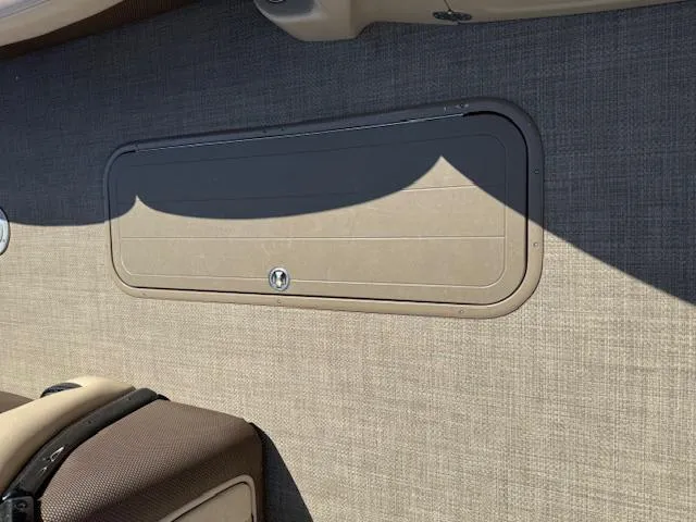 Slide: The Image of 2016 Regency 254 DL3 boat interior with storage compartment and textured wall. - 24