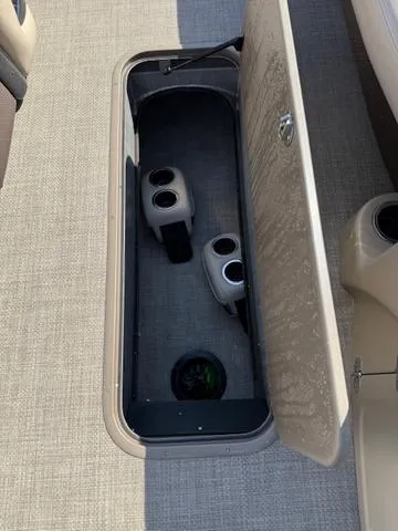 Slide: The Image of Storage compartment with cup holders on a 2016 Regency 254 DL3 boat. - 25