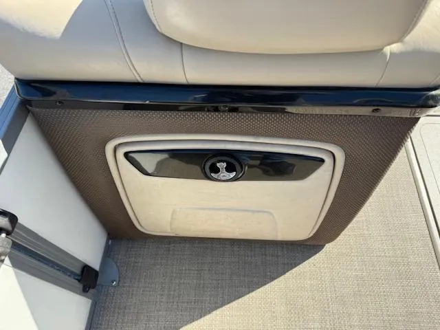 Slide: The Image of 2016 Regency 254 DL3 boat seat with storage compartment and beige upholstery. - 26