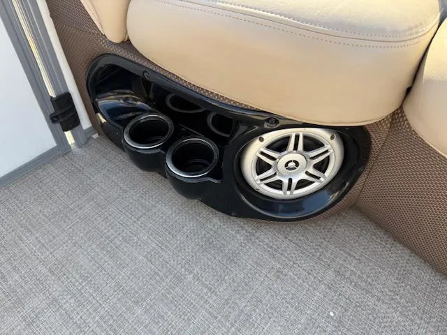 Slide: The Image of Cup holders and speaker on 2016 Regency 254 DL3 boat with beige seating. - 27