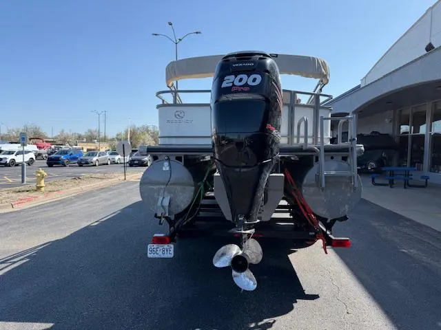 Slide: The Image of 2016 Regency 254 DL3 pontoon boat with 200 HP Mercury engine, parked outdoors. - 3