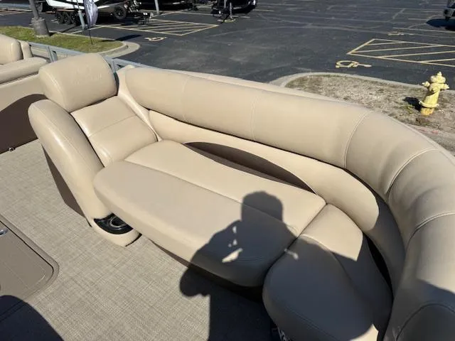 Slide: The Image of 2016 Regency 254 DL3 boat with beige seating in a parking lot. - 30