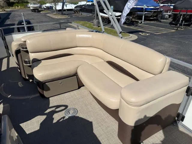 Slide: The Image of 2016 Regency 254 DL3 pontoon boat with beige seating and spacious deck layout. - 35