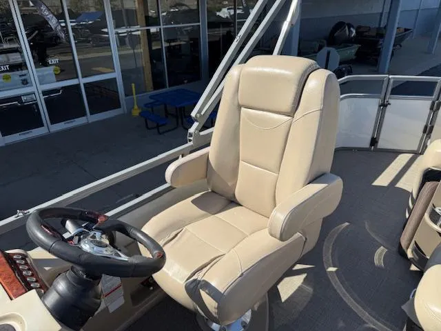 Slide: The Image of Captain's chair on 2016 Regency 254 DL3 pontoon boat, beige upholstery, near steering wheel. - 36