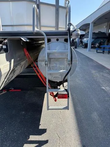 Slide: The Image of 2016 Regency 254 DL3 pontoon boat rear view with ladder and dockside setting. - 4