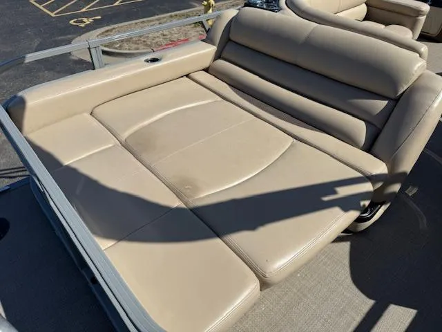 Slide: The Image of Luxurious seating on 2016 Regency 254 DL3 pontoon boat, featuring beige upholstery. - 6