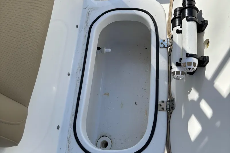 Slide: The Image of 2018 NauticStar 211 Hybrid boat storage compartment with pump system. - 2