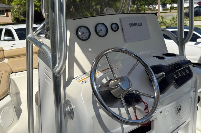 Slide: The Image of 2018 NauticStar 211 Hybrid boat console with steering wheel and gauges. - 6