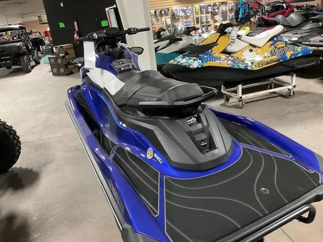 Slide: The Image of 2024 Yamaha Waverunner GP in showroom, blue and black design, sleek and modern watercraft. - 5