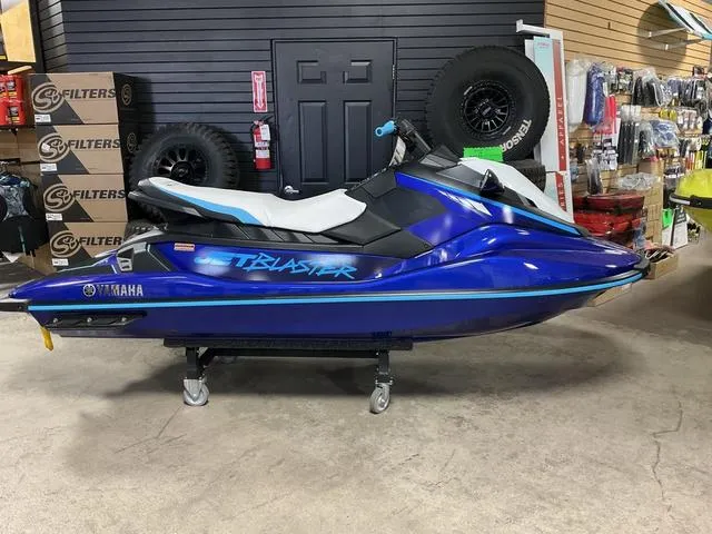 Slide: The Image of 2024 Yamaha Waverunner Jetblaster in showroom, vibrant blue color, side view. - 10