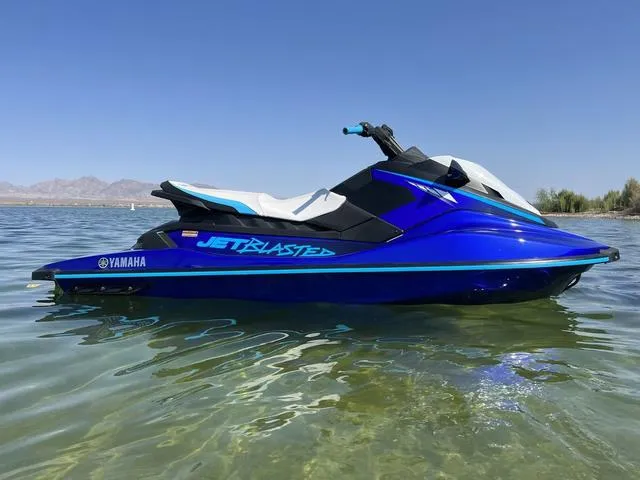 Slide: The Image of 2024 Yamaha Waverunner Jetblaster in blue, floating on clear water. - 11